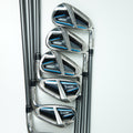 Five golf iron clubs arranged in descending size order on a clean white background, featuring a polished silver metal finish with black and blue accents on the clubheads.
