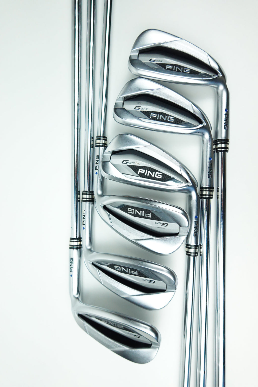 Six PING golf iron clubs arranged in a fan shape on a clean white background.