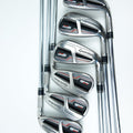 A set of six TaylorMade M6 golf iron clubs arranged diagonally on a clean white background, showing their polished metal heads and chrome shafts.
