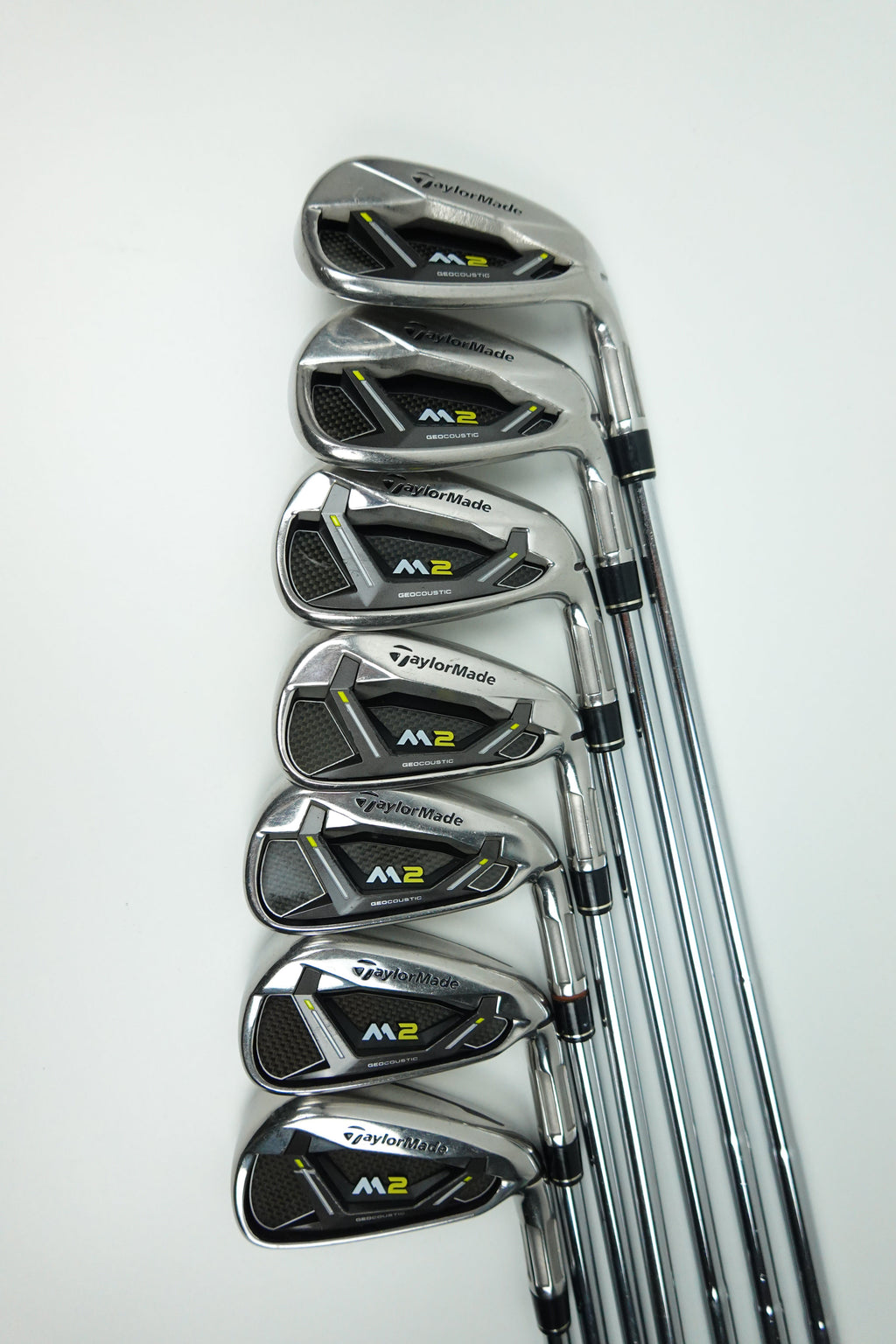 A set of seven TaylorMade M2 iron golf clubs arranged in a fan shape on a clean white background.