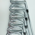 A set of seven polished steel golf irons arranged in a fan shape on a clean white background.