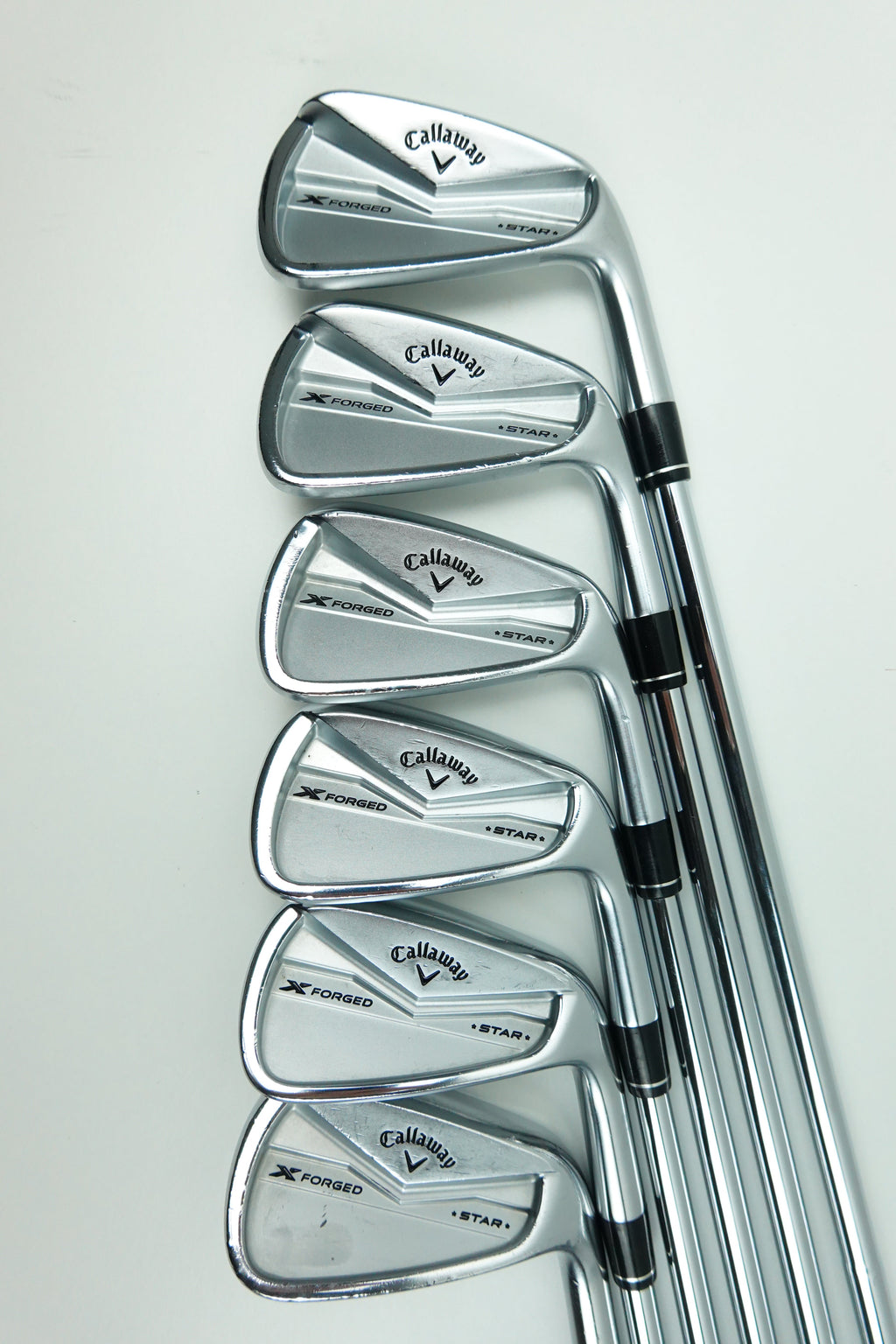 A set of five Callaway iron golf clubs arranged in a fan shape on a plain white background.