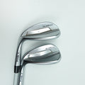Two PING golf wedges with metallic silver and black clubs, positioned diagonally on a clean white background.